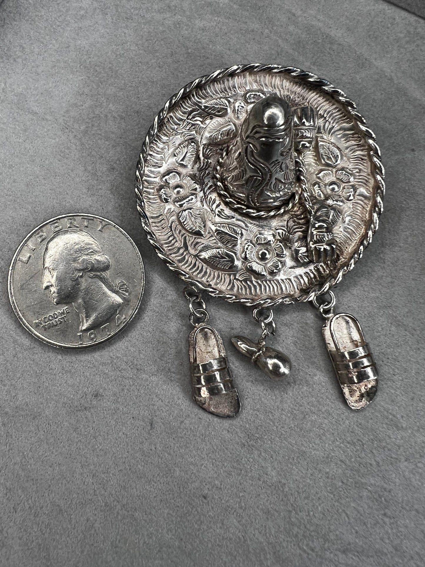 This charming 1950s sterling silver brooch captures a playful scene with a large sombrero, a pair of sandals, and a maraca. Its unique design reflects vintage character and cultural flair, making it a delightful accessory that adds personality and nostalgia to your collection.