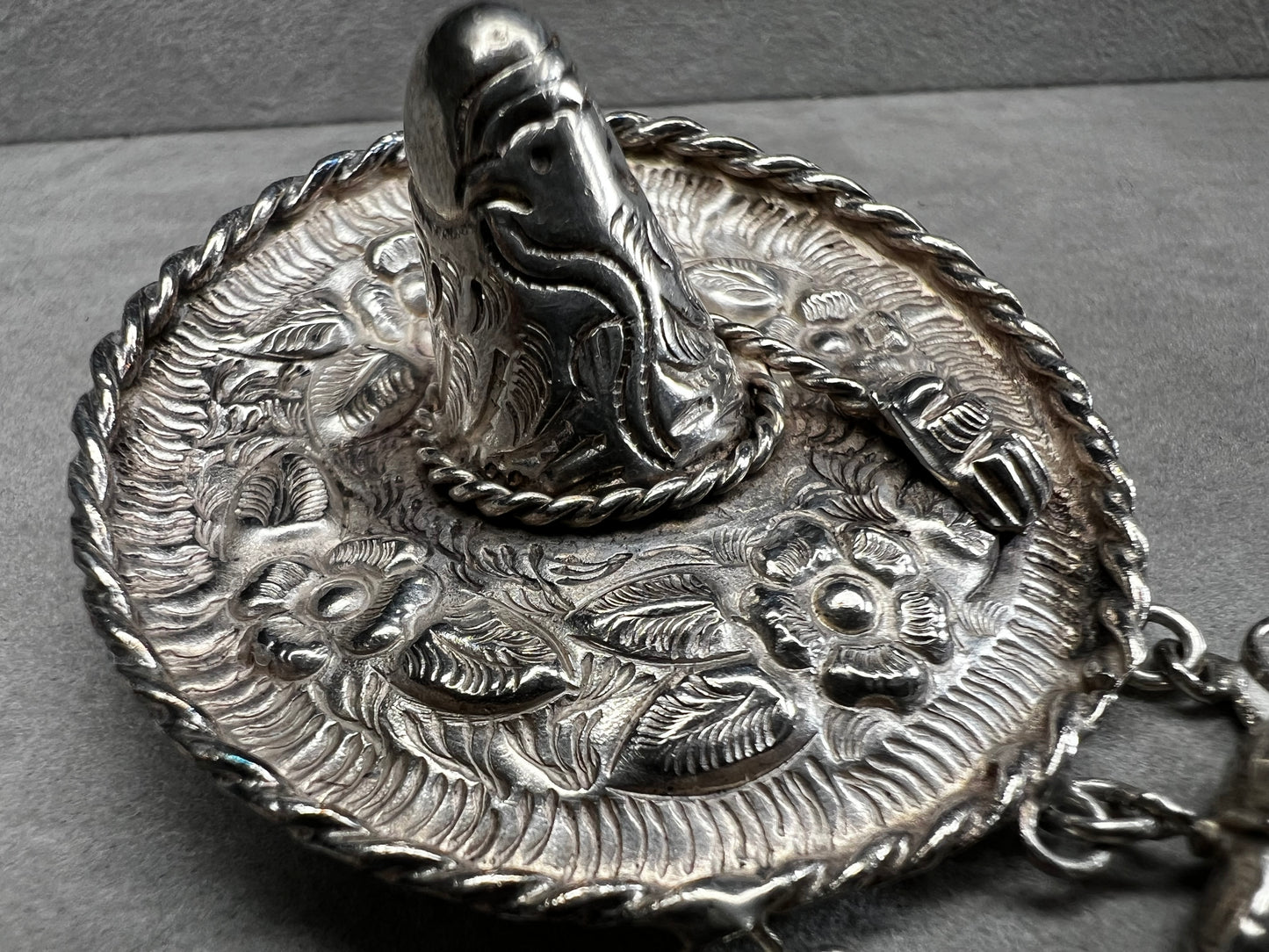 This charming 1950s sterling silver brooch captures a playful scene with a large sombrero, a pair of sandals, and a maraca. Its unique design reflects vintage character and cultural flair, making it a delightful accessory that adds personality and nostalgia to your collection.