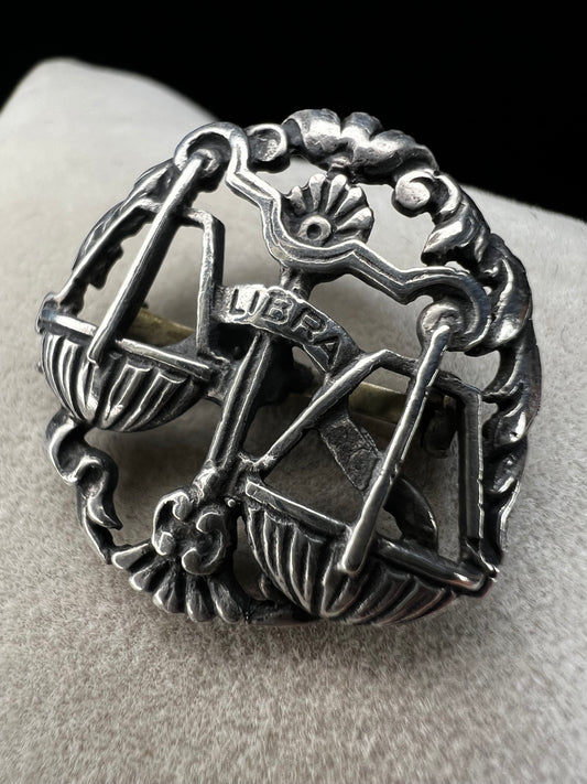 Celebrate the charm of the Libra zodiac sign with this vintage sterling silver brooch. Its timeless design makes it a thoughtful gift for anyone who appreciates astrology.