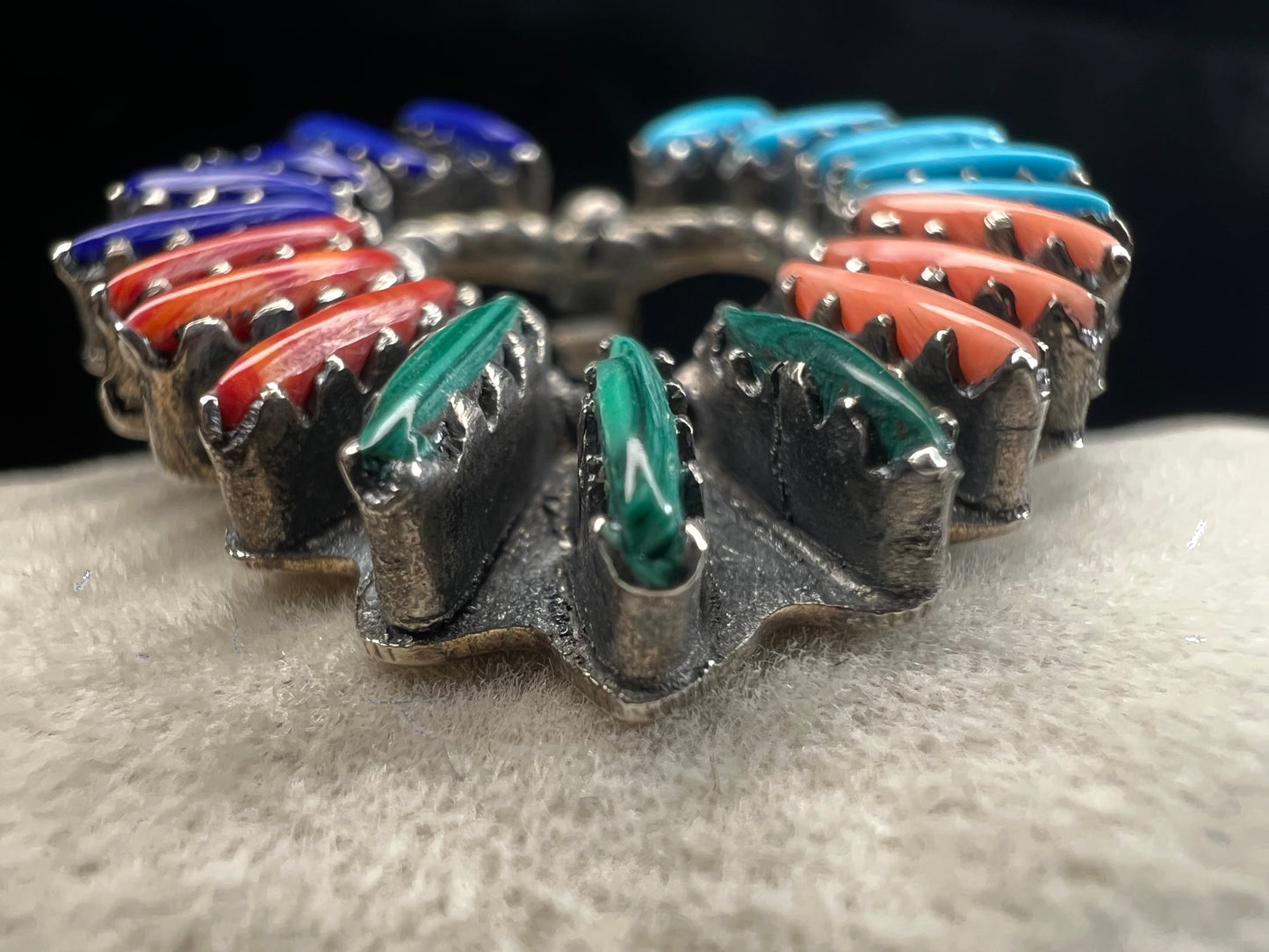 At just over an 1", this is a beautiful vintage Navajo pin done by Tom Taylor, meticulously crafted from sterling silver and natural stones. This is a special piece. There are small chips in some of the stones, but they don't take away from the pin's beauty.