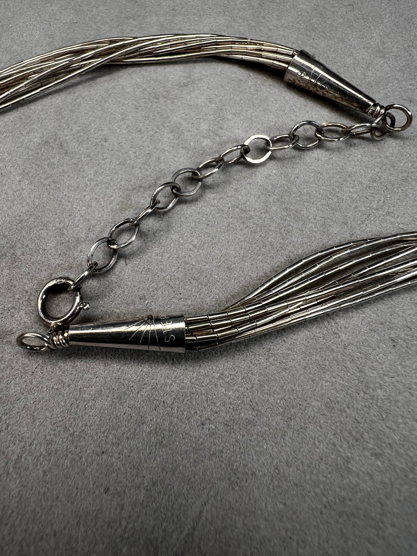 This 18-inch sterling silver "Liquid Sterling" necklace features 10 delicate strands that move gracefully with you, capturing and reflecting light beautifully.