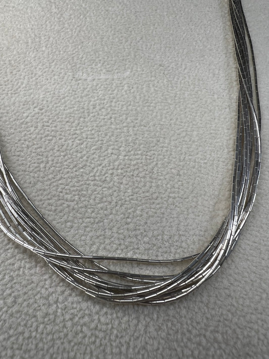This 18-inch sterling silver "Liquid Sterling" necklace features 10 delicate strands that move gracefully with you, capturing and reflecting light beautifully.