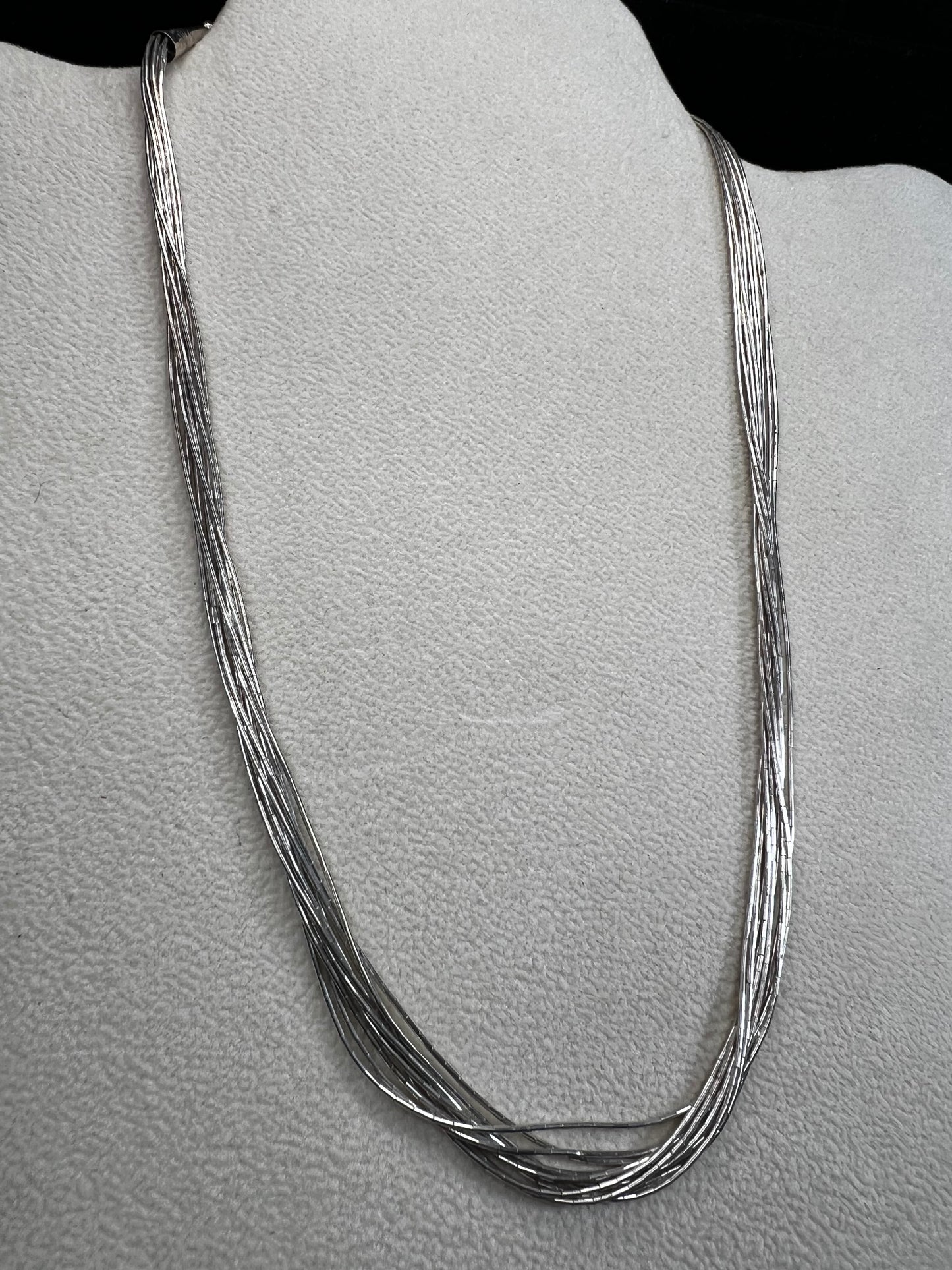 This 18-inch sterling silver "Liquid Sterling" necklace features 10 delicate strands that move gracefully with you, capturing and reflecting light beautifully.