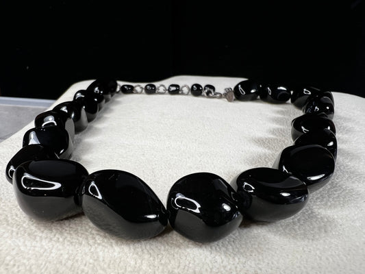 This necklace from LSB Designs features natural black onyx beads and sterling silver, combining striking beauty with lasting durability. Designed to impress, it offers a bold yet elegant accessory that enhances any look.