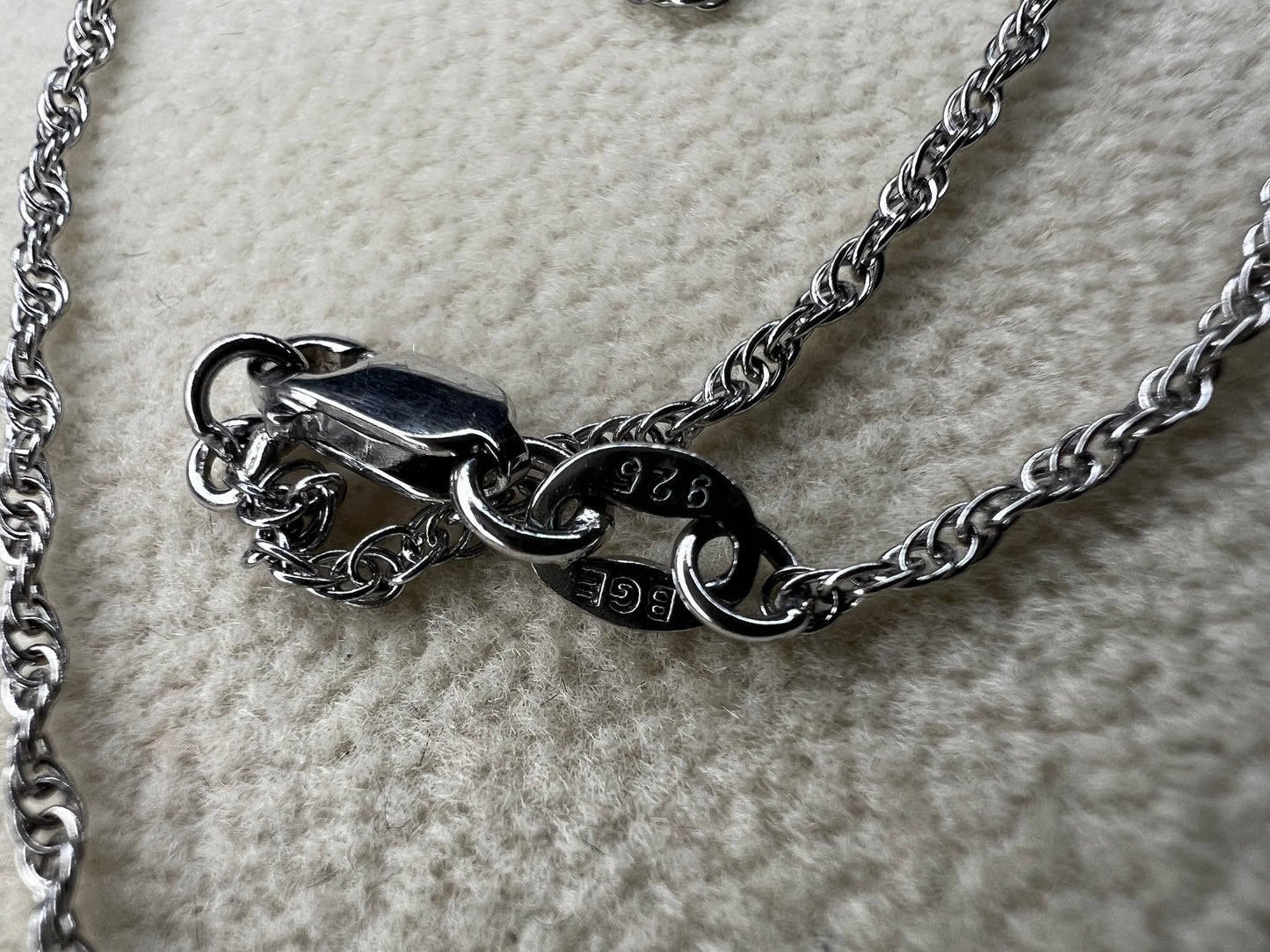 This petite sterling silver rope chain offers a delicate and elegant look, perfect for everyday wear. It pairs beautifully with smaller pendants or can be worn alone for a subtle touch of sophistication.