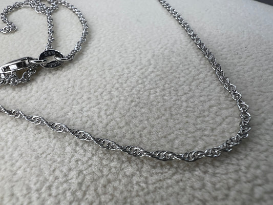 This petite sterling silver rope chain offers a delicate and elegant look, perfect for everyday wear. It pairs beautifully with smaller pendants or can be worn alone for a subtle touch of sophistication.