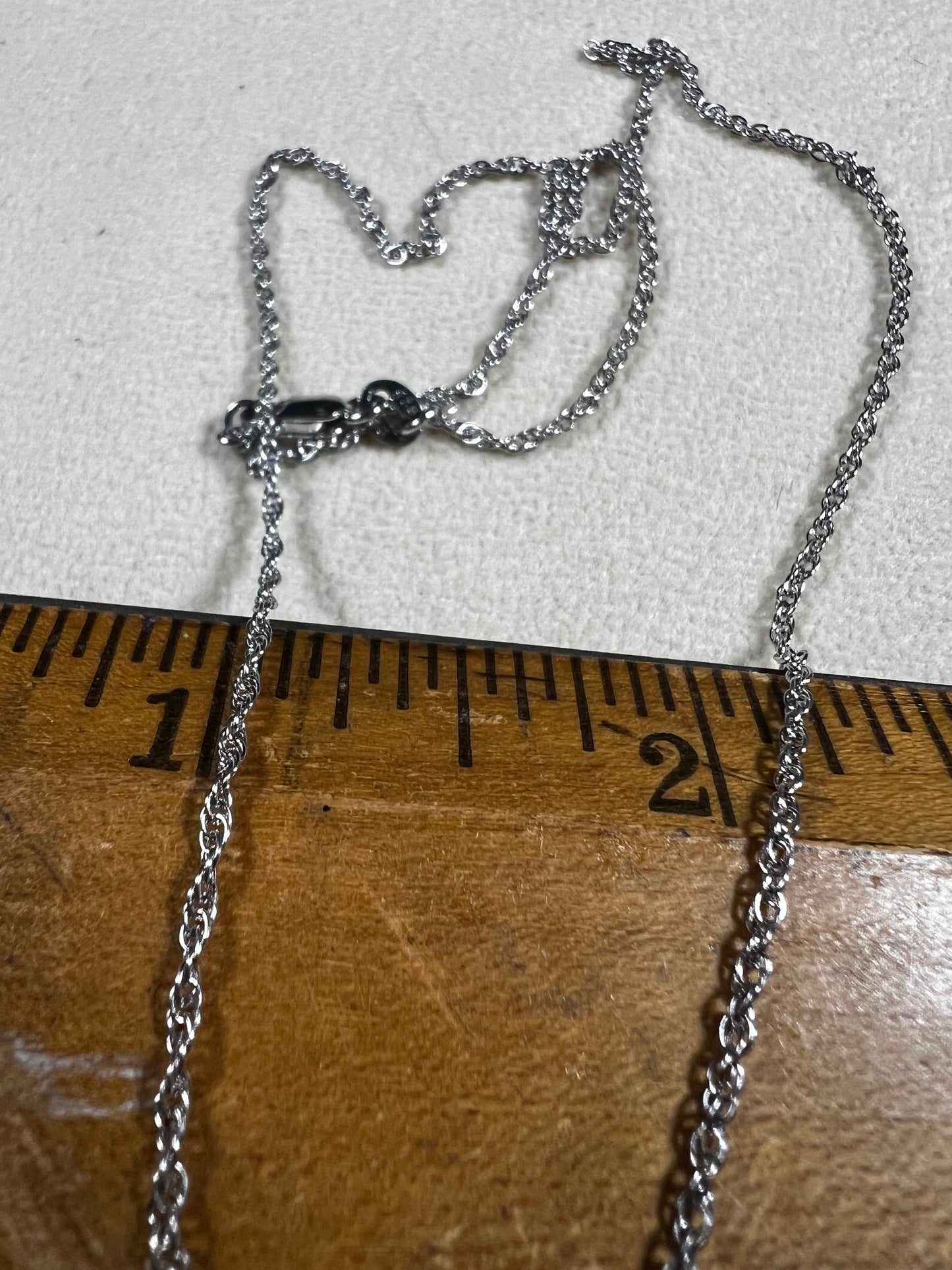 This petite sterling silver rope chain offers a delicate and elegant look, perfect for everyday wear. It pairs beautifully with smaller pendants or can be worn alone for a subtle touch of sophistication.