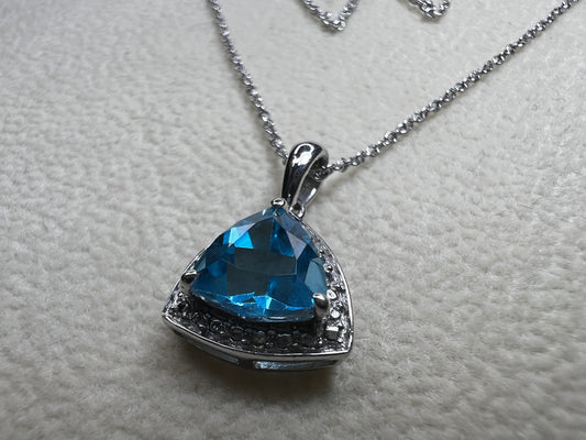 This 18" sterling silver chain paired with a petite blue topaz pendant offers a vibrant pop of color without overwhelming your look. Crafted for elegance and subtlety, it adds a refined sparkle that complements any outfit.