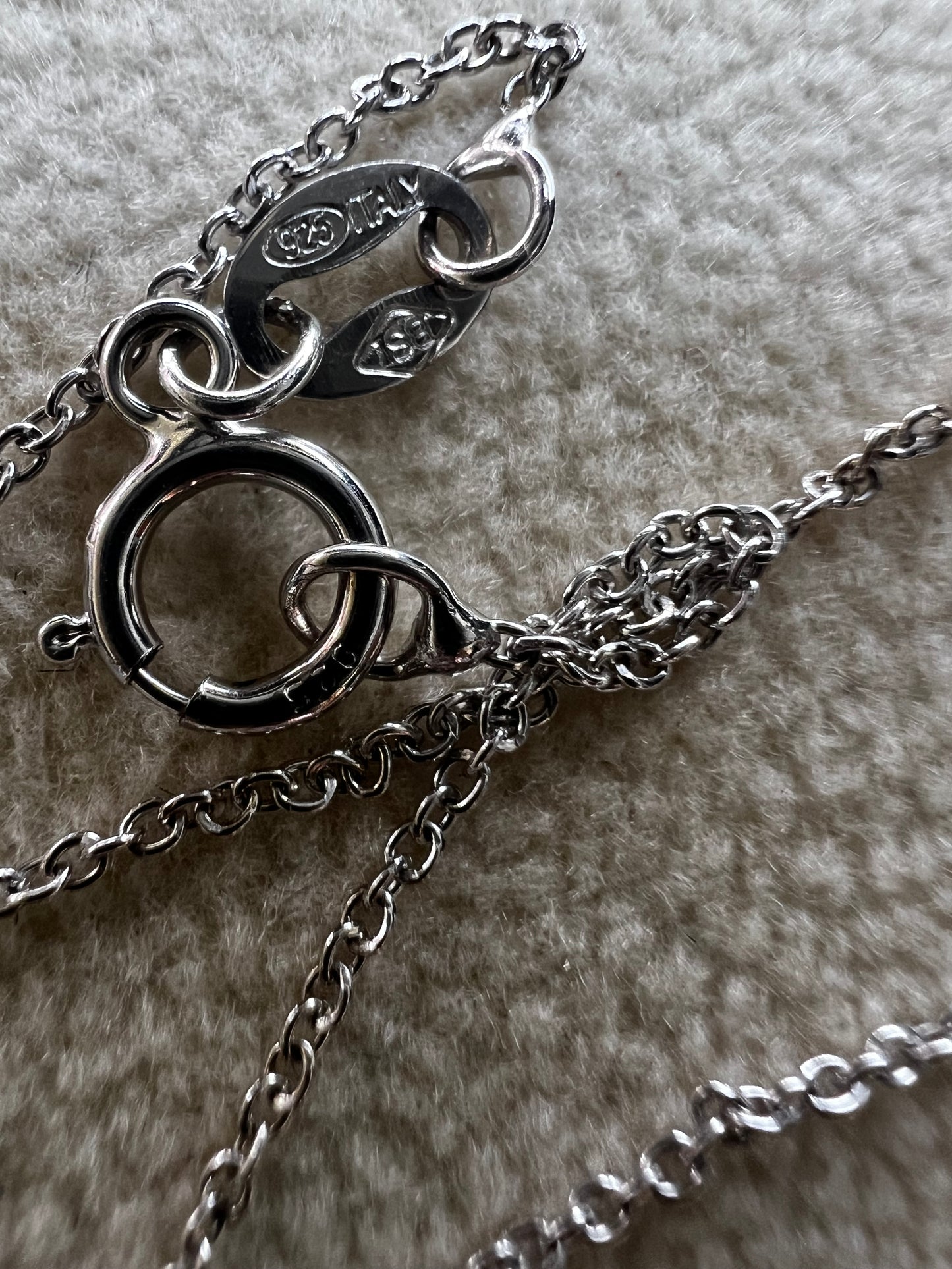 This 18" sterling silver chain paired with a petite blue topaz pendant offers a vibrant pop of color without overwhelming your look. Crafted for elegance and subtlety, it adds a refined sparkle that complements any outfit.