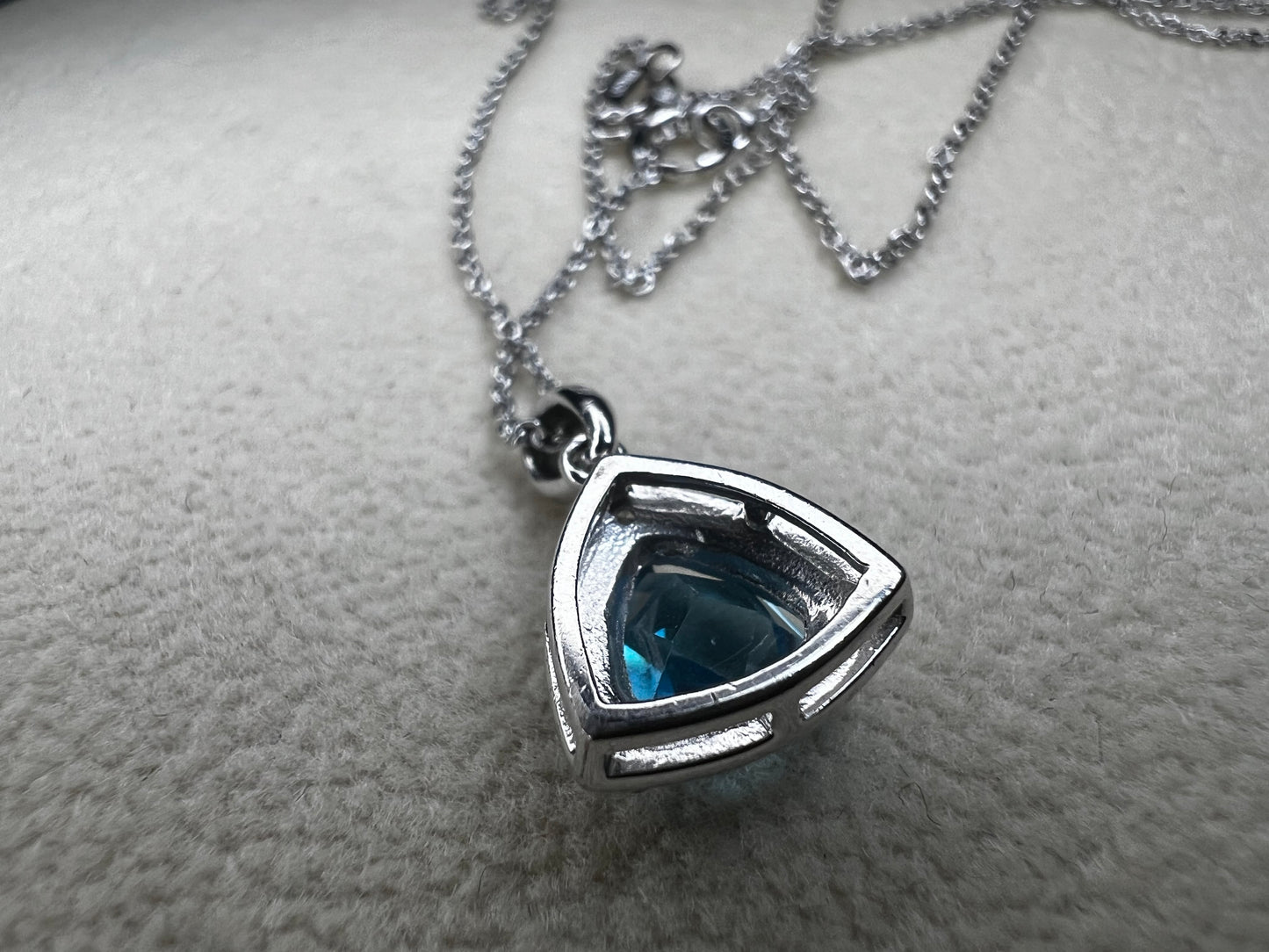 This 18" sterling silver chain paired with a petite blue topaz pendant offers a vibrant pop of color without overwhelming your look. Crafted for elegance and subtlety, it adds a refined sparkle that complements any outfit.