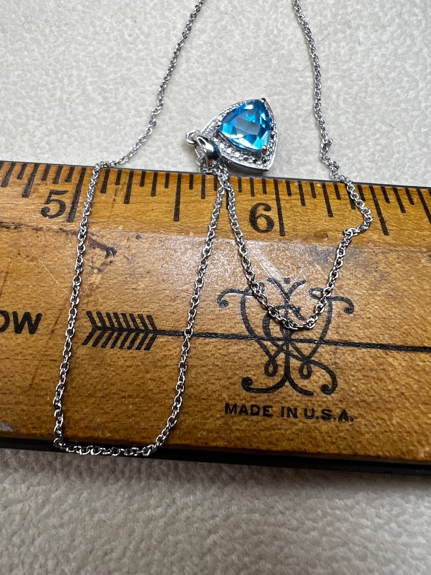 This 18" sterling silver chain paired with a petite blue topaz pendant offers a vibrant pop of color without overwhelming your look. Crafted for elegance and subtlety, it adds a refined sparkle that complements any outfit.