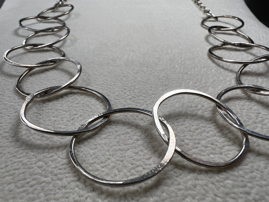 This 20" sterling silver ring and link necklace is thoughtfully crafted to add a touch of elegance and confidence to your favorite outfits. Let this necklace be the special piece that completes your wardrobe with grace and charm.