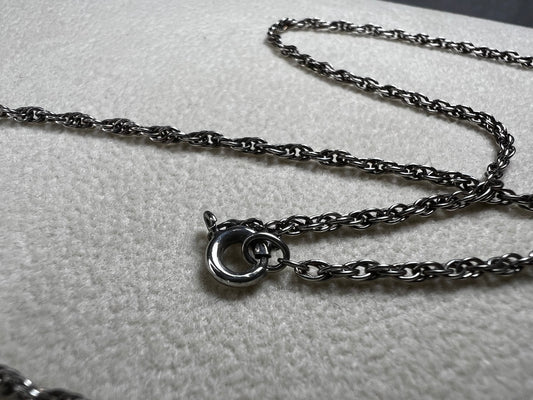 This vintage classic sterling silver 18" rope chain offers a subtle touch of timeless style. Its delicate design works beautifully on its own or as a perfect complement to one of our pendants.