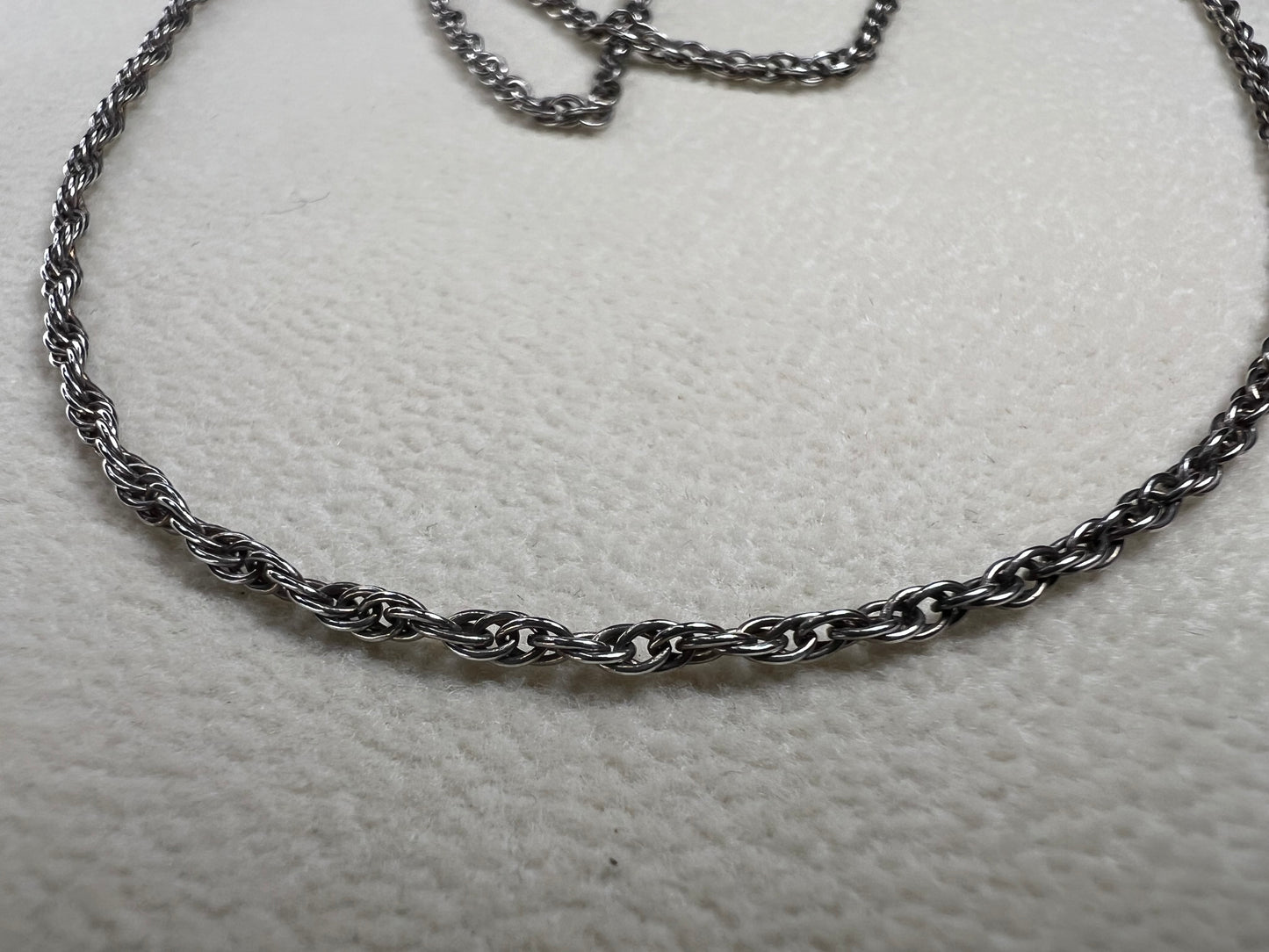 This vintage classic sterling silver 18" rope chain offers a subtle touch of timeless style. Its delicate design works beautifully on its own or as a perfect complement to one of our pendants.