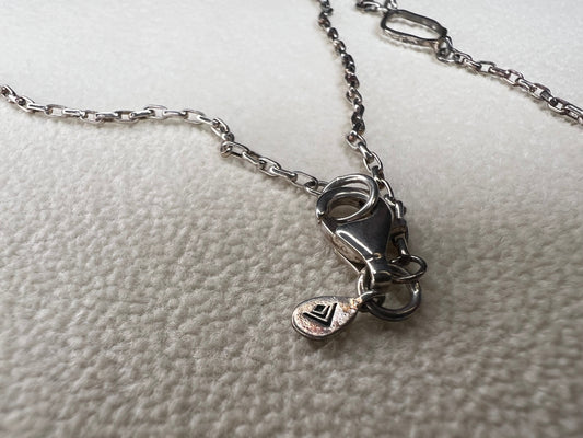 This retired Silpada necklace, measuring 34" in length, is crafted from sterling silver and accented with a few sparkling cubic zirconia stones. This "Ring Around the Rosy" necklace offers a subtle flash of light, making it a charming and elegant addition to any jewelry collection.