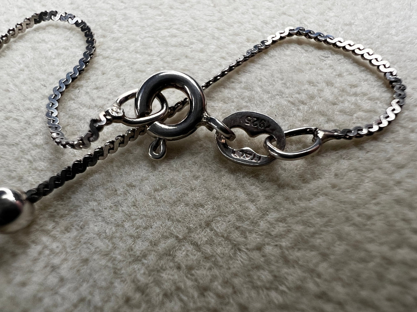This vintage Italian sterling silver necklace features 11 small sterling silver balls spaced apart, creating an elegant and distinctive design. Its timeless style makes it a versatile accessory that enhances any outfit with subtle sophistication.