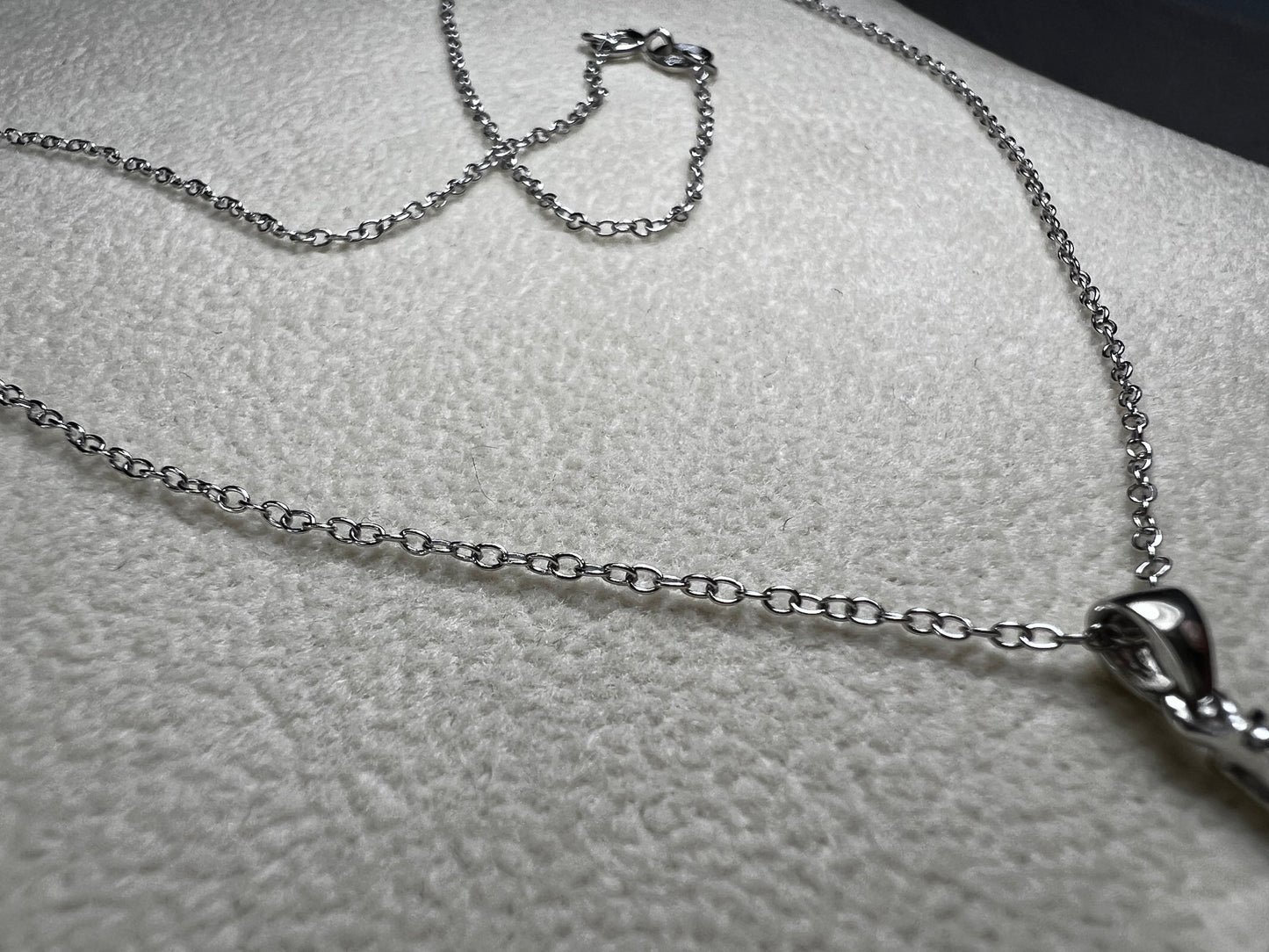 This sterling silver cross pendant necklace from V3 Jewelers features a single center diamond, combining classic design with subtle sparkle. This is a meaningful accessory that adds a graceful touch to any outfit while symbolizing faith and style.