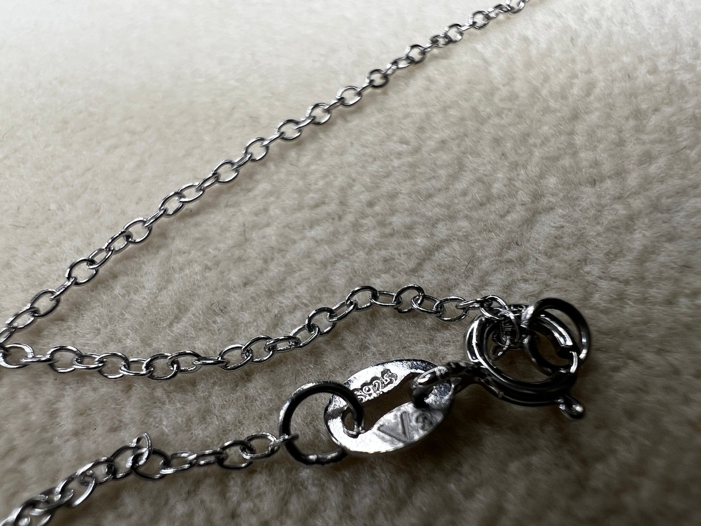 This sterling silver cross pendant necklace from V3 Jewelers features a single center diamond, combining classic design with subtle sparkle. This is a meaningful accessory that adds a graceful touch to any outfit while symbolizing faith and style.