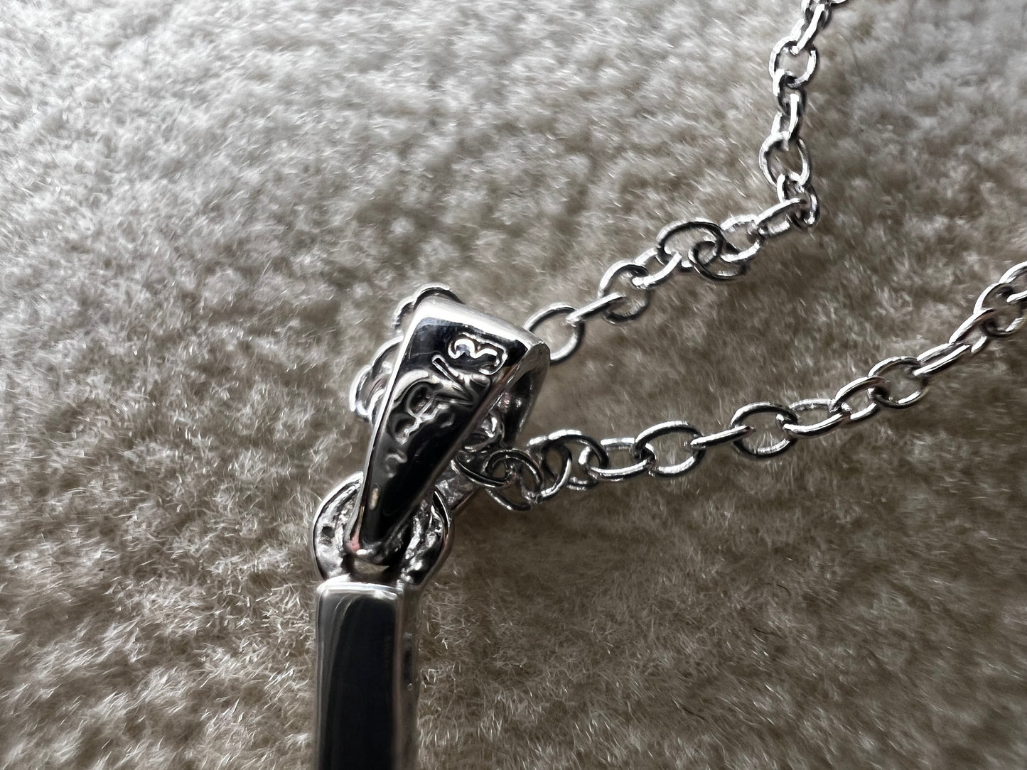 This sterling silver cross pendant necklace from V3 Jewelers features a single center diamond, combining classic design with subtle sparkle. This is a meaningful accessory that adds a graceful touch to any outfit while symbolizing faith and style.