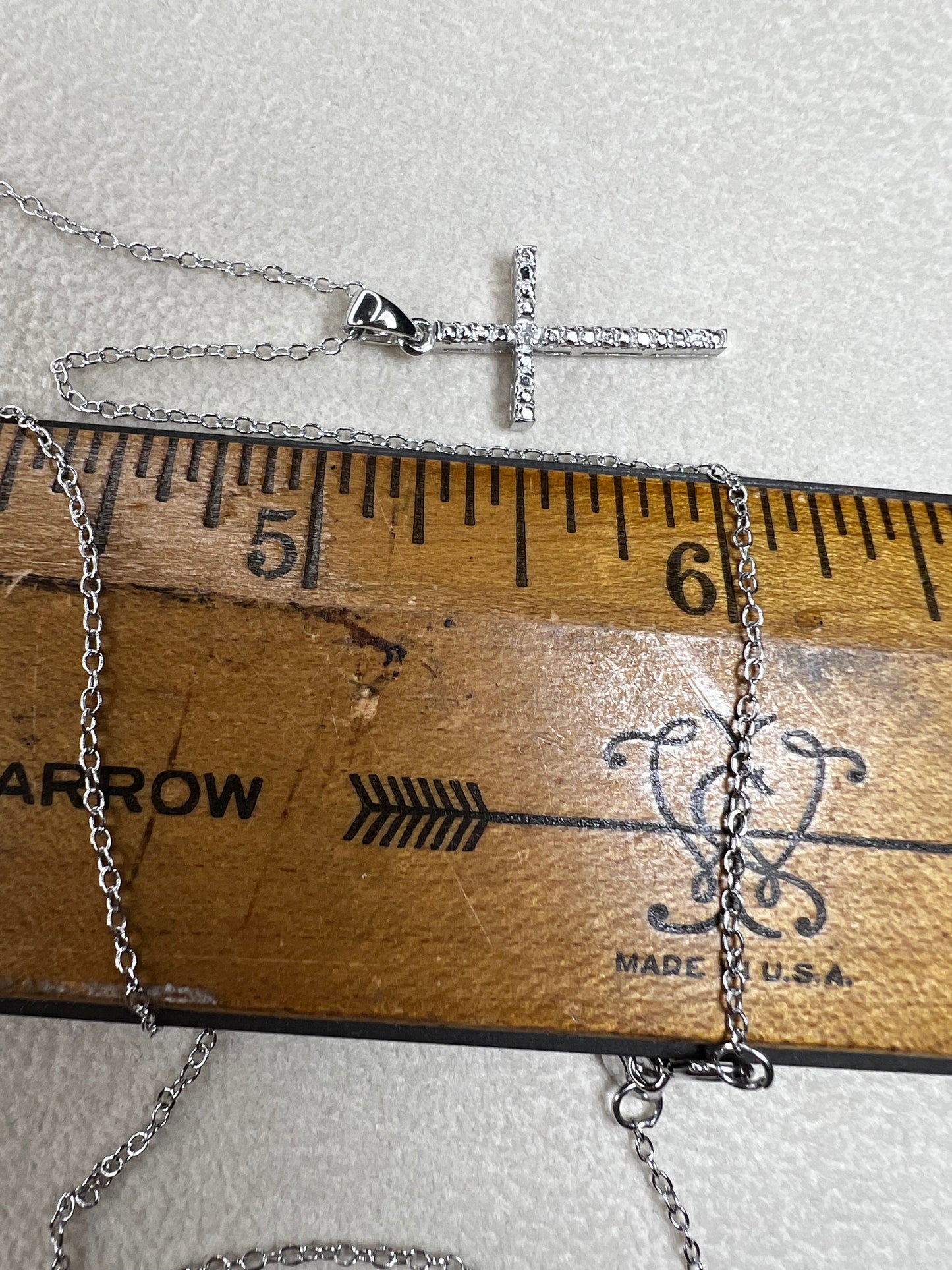This sterling silver cross pendant necklace from V3 Jewelers features a single center diamond, combining classic design with subtle sparkle. This is a meaningful accessory that adds a graceful touch to any outfit while symbolizing faith and style.