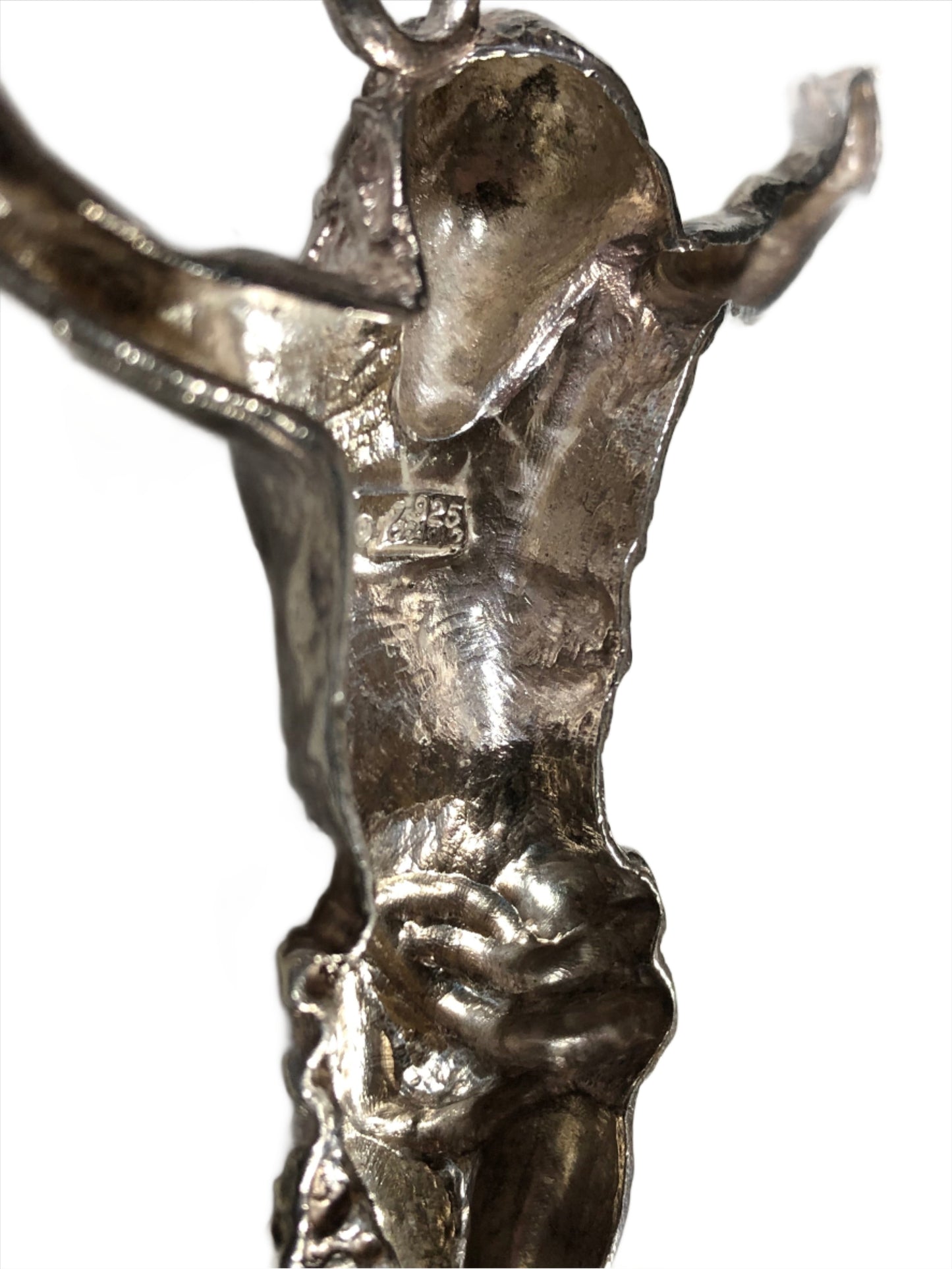 TThis hand-crafted sterling silver pendant, featuring Jesus with arms outstretched as if on the Cross, is an impressive 4.75 inches from toe-tip to the bail's top. On the back of this piece, "1 of a kind" is inscribed.