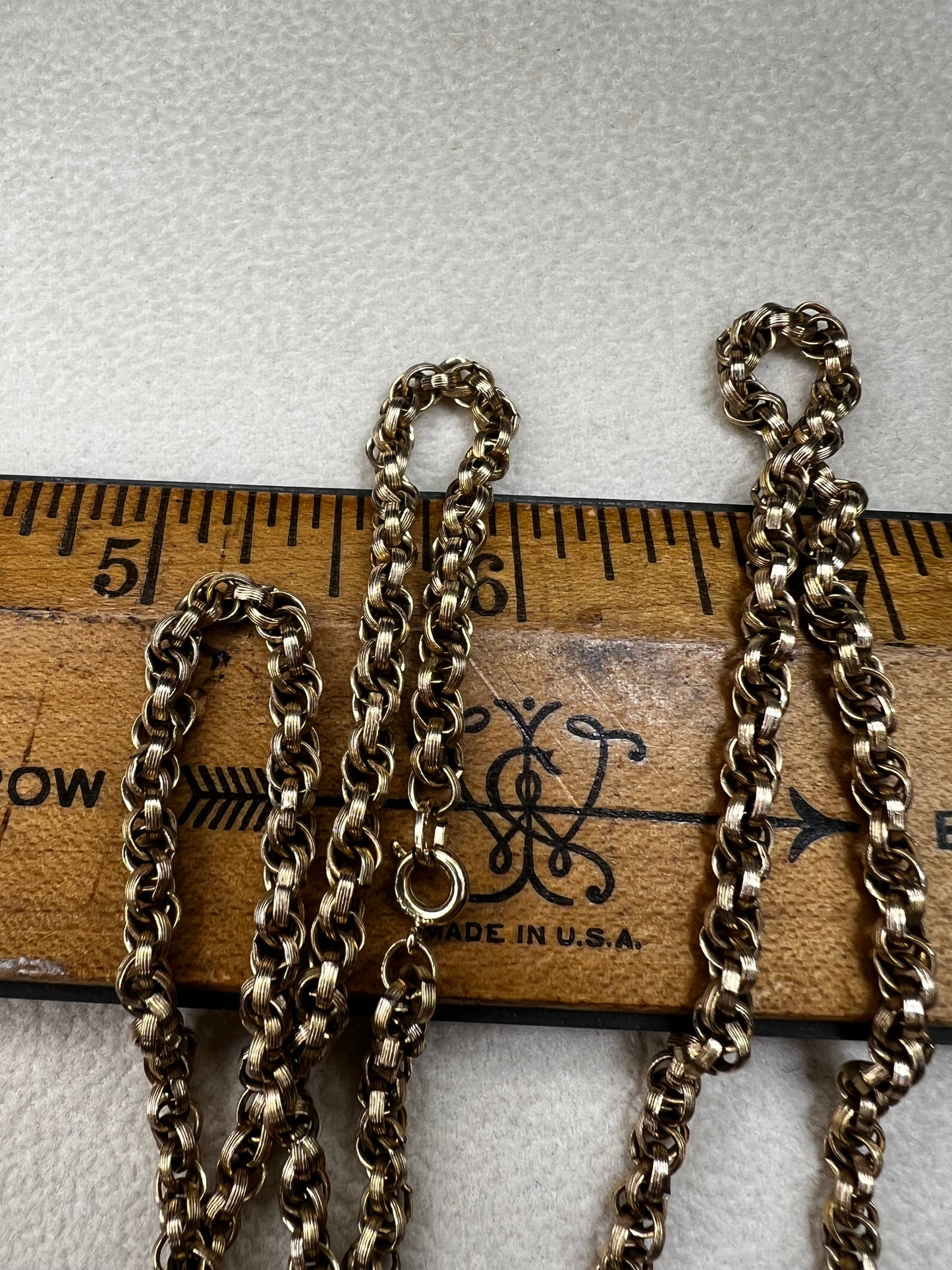 This vintage 26" gold-filled chain features a sturdy double spiral weave, measuring 3.5mm thick for lasting strength. Its elegant gold finish shines on its own while providing a reliable base for any pendant.