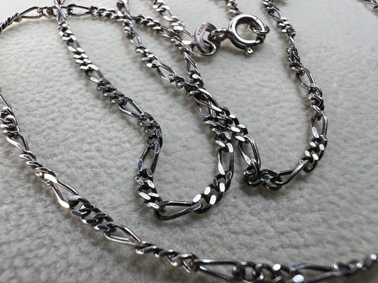 This 18" sterling silver chain from India features a classic Figaro link design, offering versatile style. It pairs perfectly with a small pendant or can be worn alone for a subtle, elegant touch to any look.