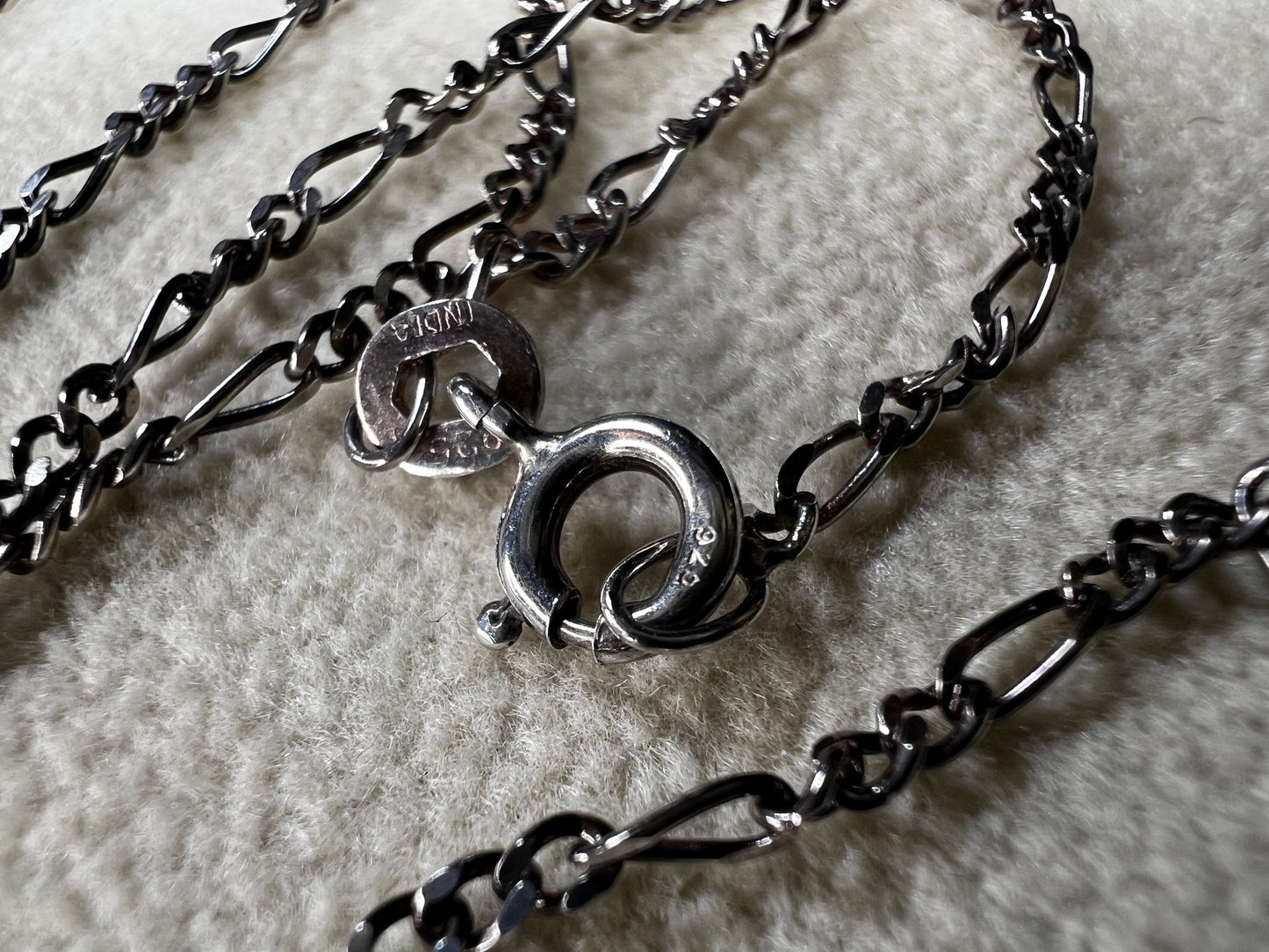 This 18" sterling silver chain from India features a classic Figaro link design, offering versatile style. It pairs perfectly with a small pendant or can be worn alone for a subtle, elegant touch to any look.