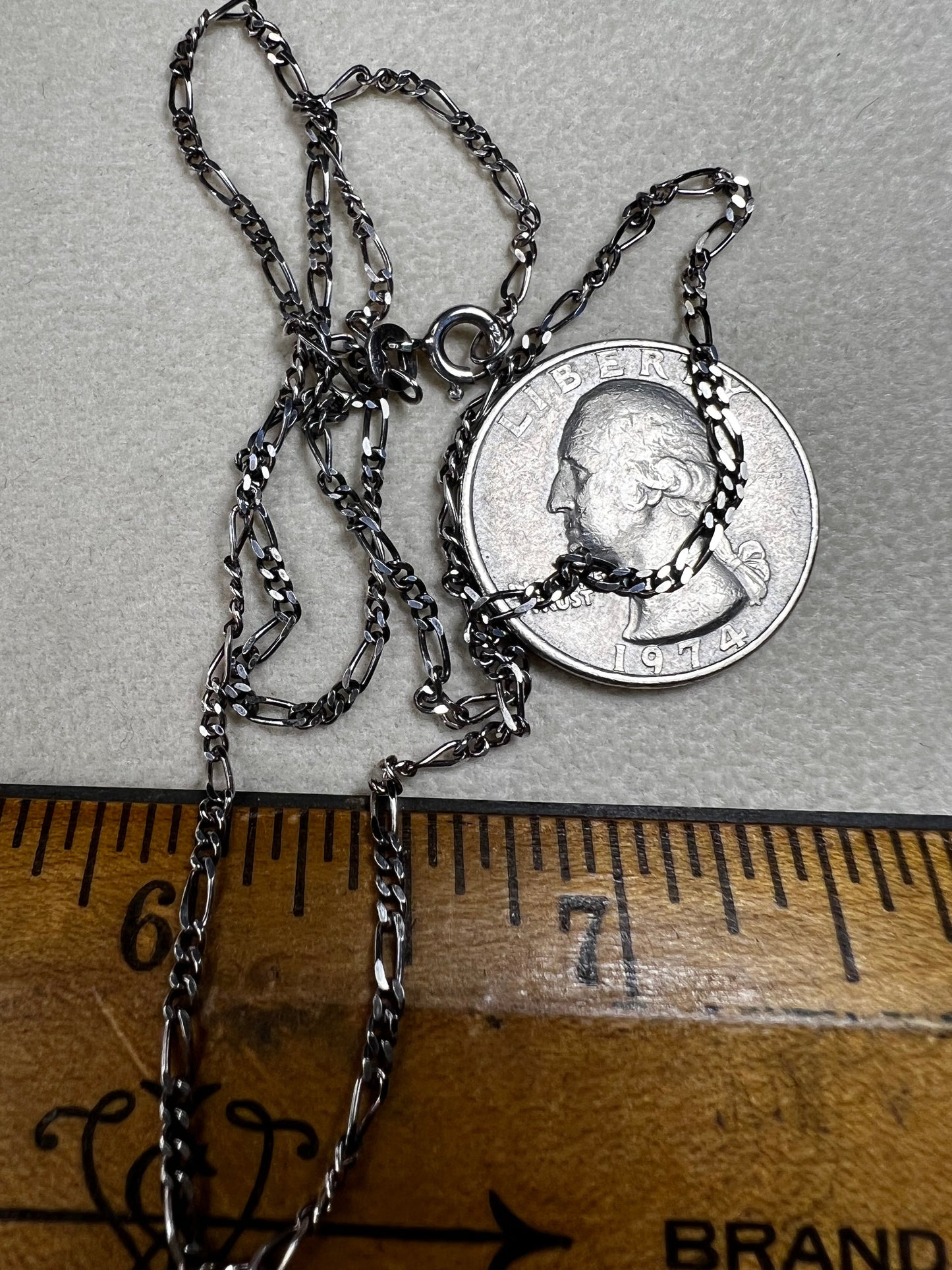 This 18" sterling silver chain from India features a classic Figaro link design, offering versatile style. It pairs perfectly with a small pendant or can be worn alone for a subtle, elegant touch to any look.