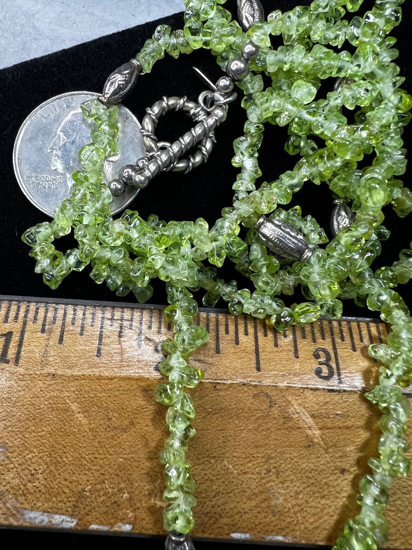This 36-inch necklace features natural peridot chips expertly strung and paired with sterling silver components. Its vibrant green hues bring a refreshing touch, while sterling silver ensures durability and elegance. Made in India.