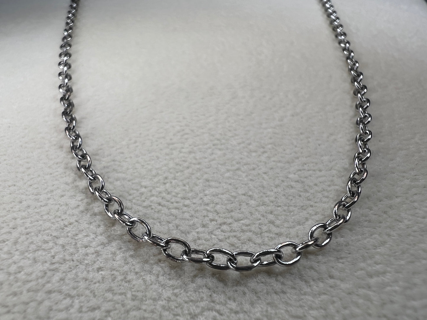 This 24" sterling silver cable chain offers a durable and elegant look that works beautifully on its own or combined with your favorite pendant. Its sturdy design ensures long-lasting wear while adding a subtle shine to your everyday style.