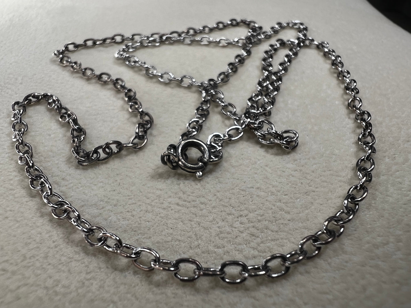 This 24" sterling silver cable chain offers a durable and elegant look that works beautifully on its own or combined with your favorite pendant. Its sturdy design ensures long-lasting wear while adding a subtle shine to your everyday style.