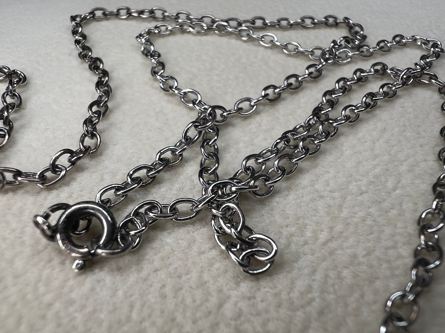 This 24" sterling silver cable chain offers a durable and elegant look that works beautifully on its own or combined with your favorite pendant. Its sturdy design ensures long-lasting wear while adding a subtle shine to your everyday style.