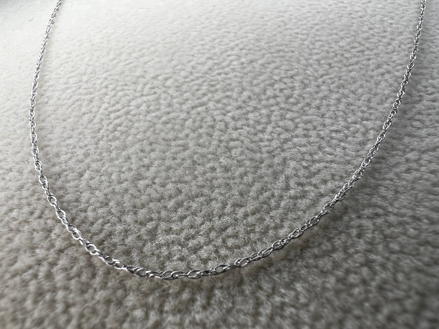 This petite 21" 14 karat white gold chain is a delicate touch of everyday elegance. It's so light that you’ll barely notice it’s there, catching the light to add subtle shine throughout your day. Perfect for layering or wearing alone.