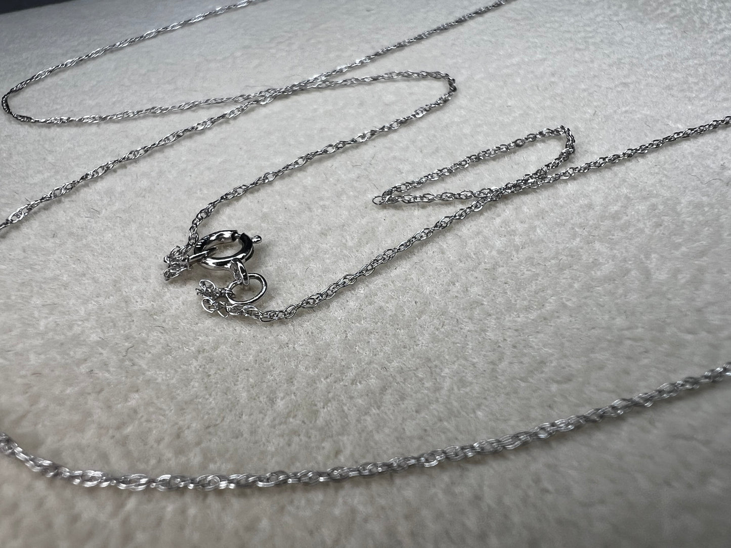 This petite 21" 14 karat white gold chain is a delicate touch of everyday elegance. It's so light that you’ll barely notice it’s there, catching the light to add subtle shine throughout your day. Perfect for layering or wearing alone.