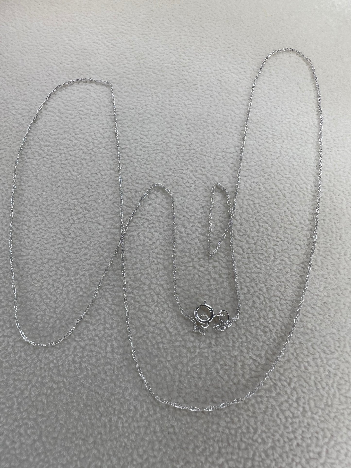 This petite 21" 14 karat white gold chain is a delicate touch of everyday elegance. It's so light that you’ll barely notice it’s there, catching the light to add subtle shine throughout your day. Perfect for layering or wearing alone.