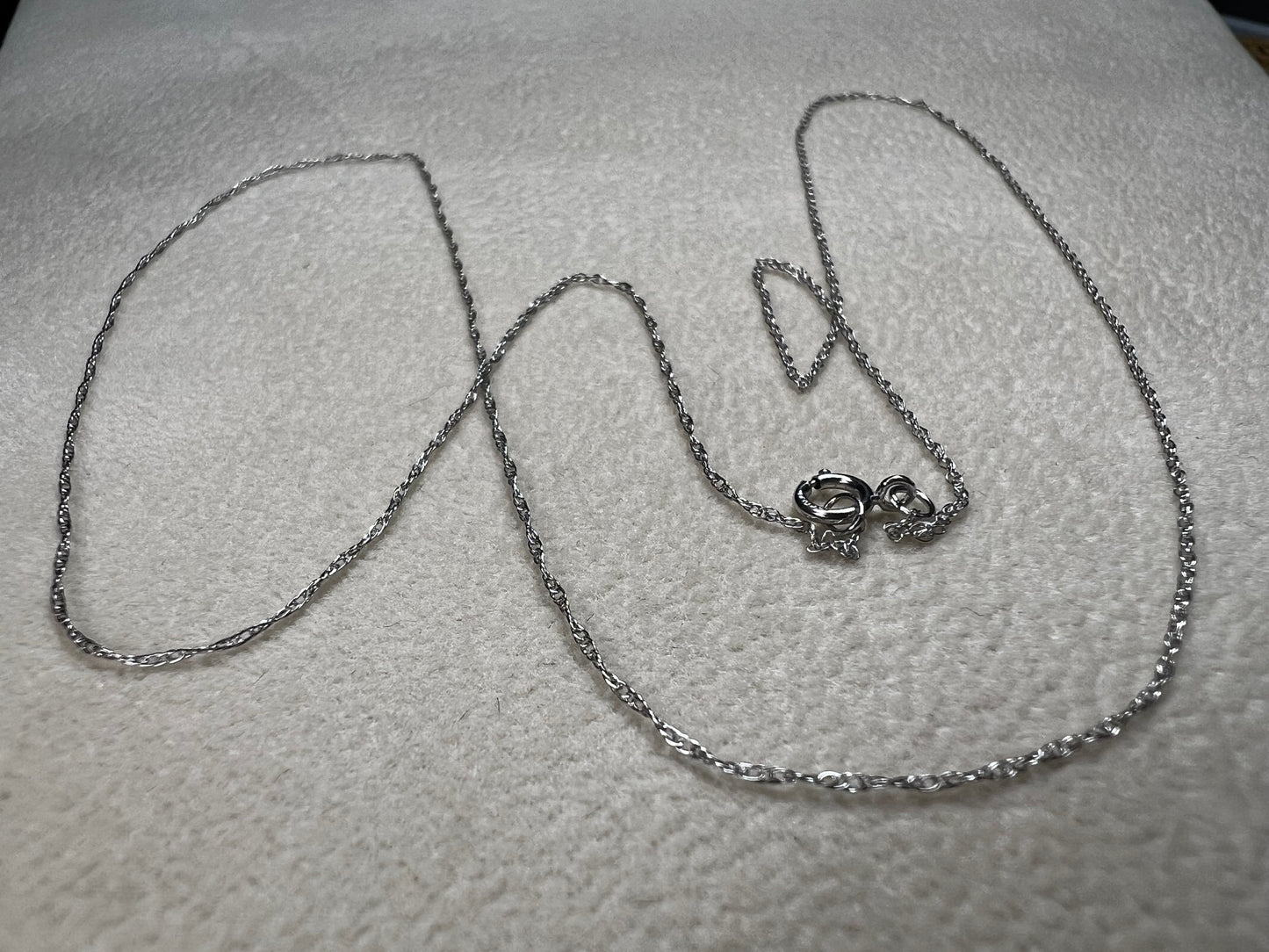 This petite 21" 14 karat white gold chain is a delicate touch of everyday elegance. It's so light that you’ll barely notice it’s there, catching the light to add subtle shine throughout your day. Perfect for layering or wearing alone.