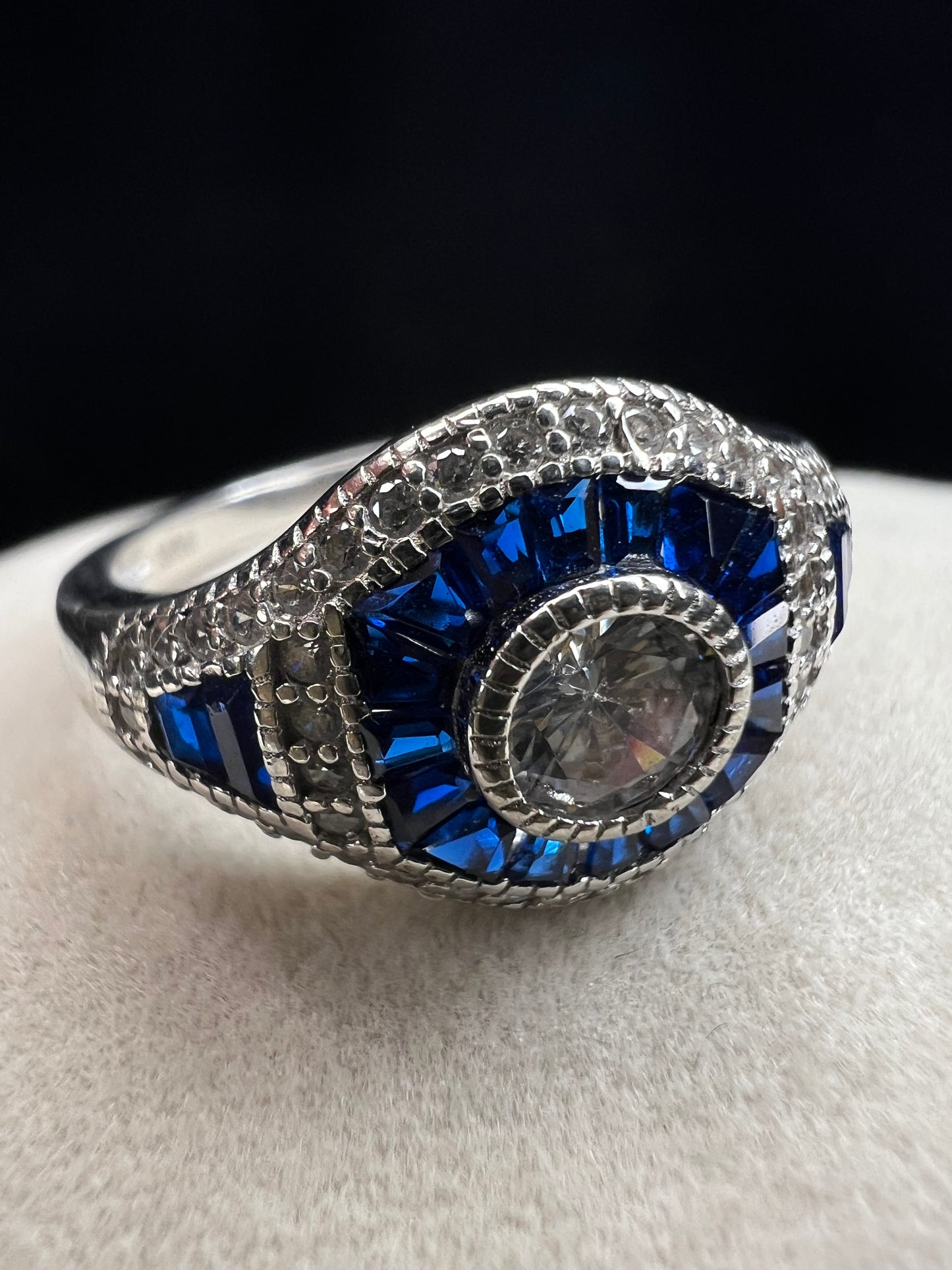This sterling silver ring showcases exquisite Art Deco design. Featuring captivating blue spinel and quartz stones, it highlights meticulous craftsmanship and a balanced color palette, making it a standout piece for collectors and connoisseurs of fine jewelry. Signed MM.