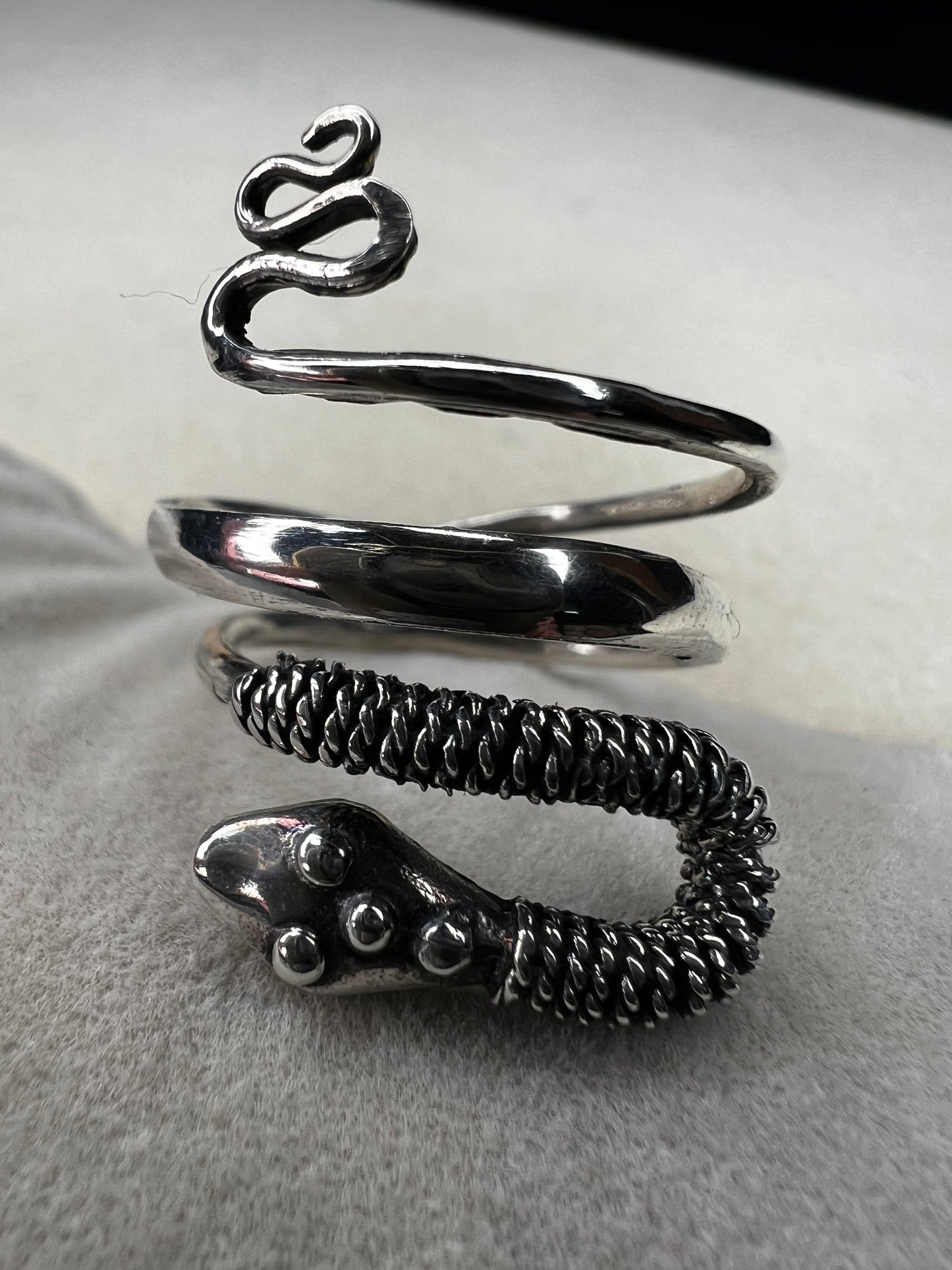 This sterling silver snake wrap ring gently coils around your finger with an open design, allowing for easy size adjustment. Its flexible fit ensures comfortable wear while adding a sleek, stylish touch to your collection.