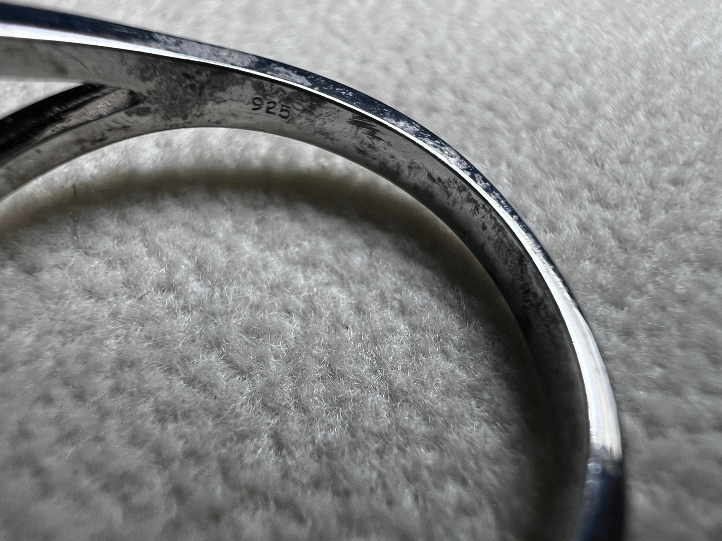 This sterling silver ring showcases a large, blue trilliant cut crackled quartz, creating a captivating centerpiece. Perfect for adding a touch of elegance and distinctiveness to any outfit.