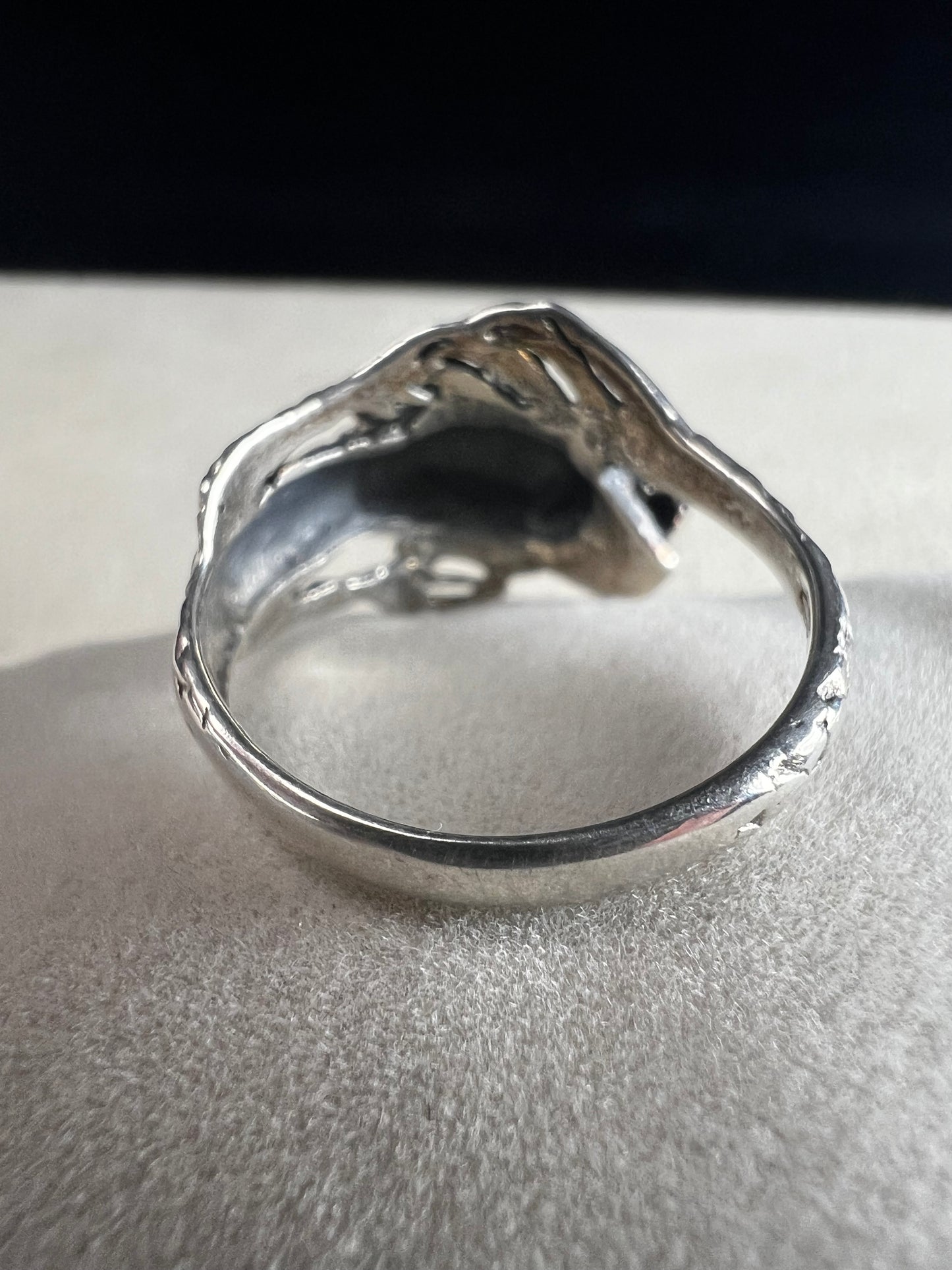 Add a touch of fierce charm to your style with this sterling silver dragon ring. Its detailed design wraps around your finger like a mythical guardian, making it the perfect statement piece.