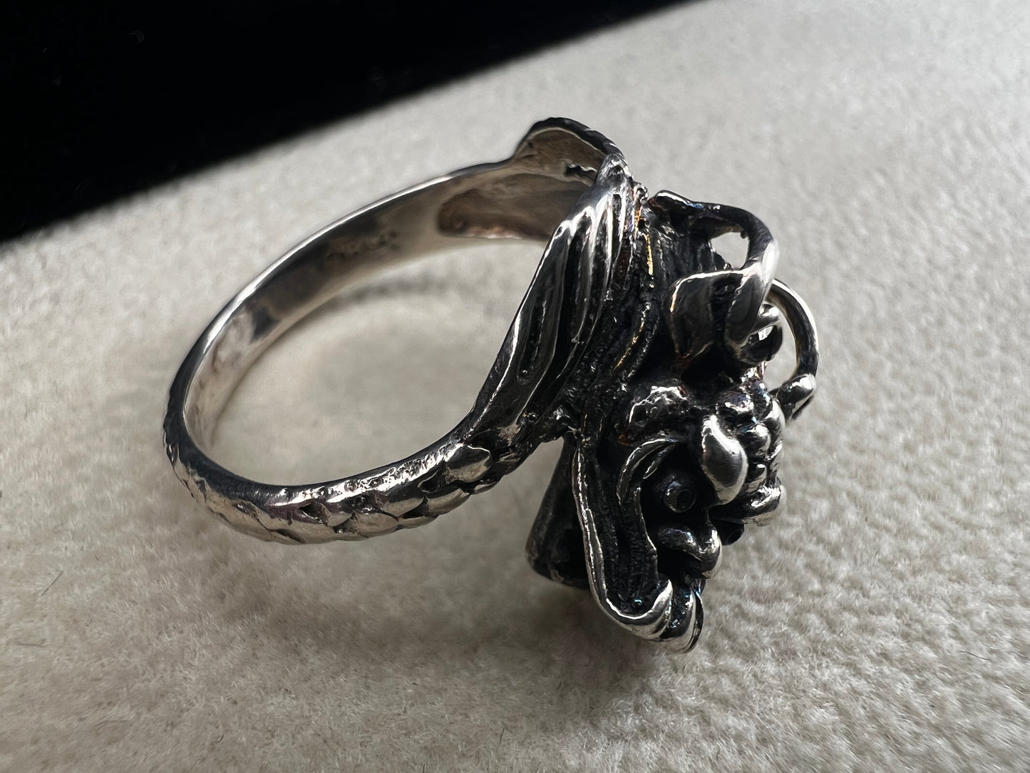 Add a touch of fierce charm to your style with this sterling silver dragon ring. Its detailed design wraps around your finger like a mythical guardian, making it the perfect statement piece.
