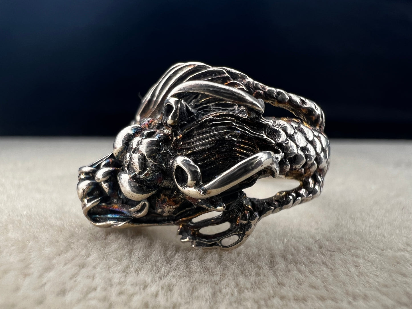 Add a touch of fierce charm to your style with this sterling silver dragon ring. Its detailed design wraps around your finger like a mythical guardian, making it the perfect statement piece.
