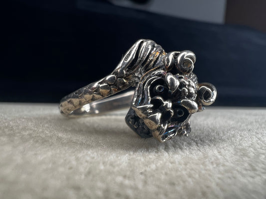 Add a touch of fierce charm to your style with this sterling silver dragon ring. Its detailed design wraps around your finger like a mythical guardian, making it the perfect statement piece.