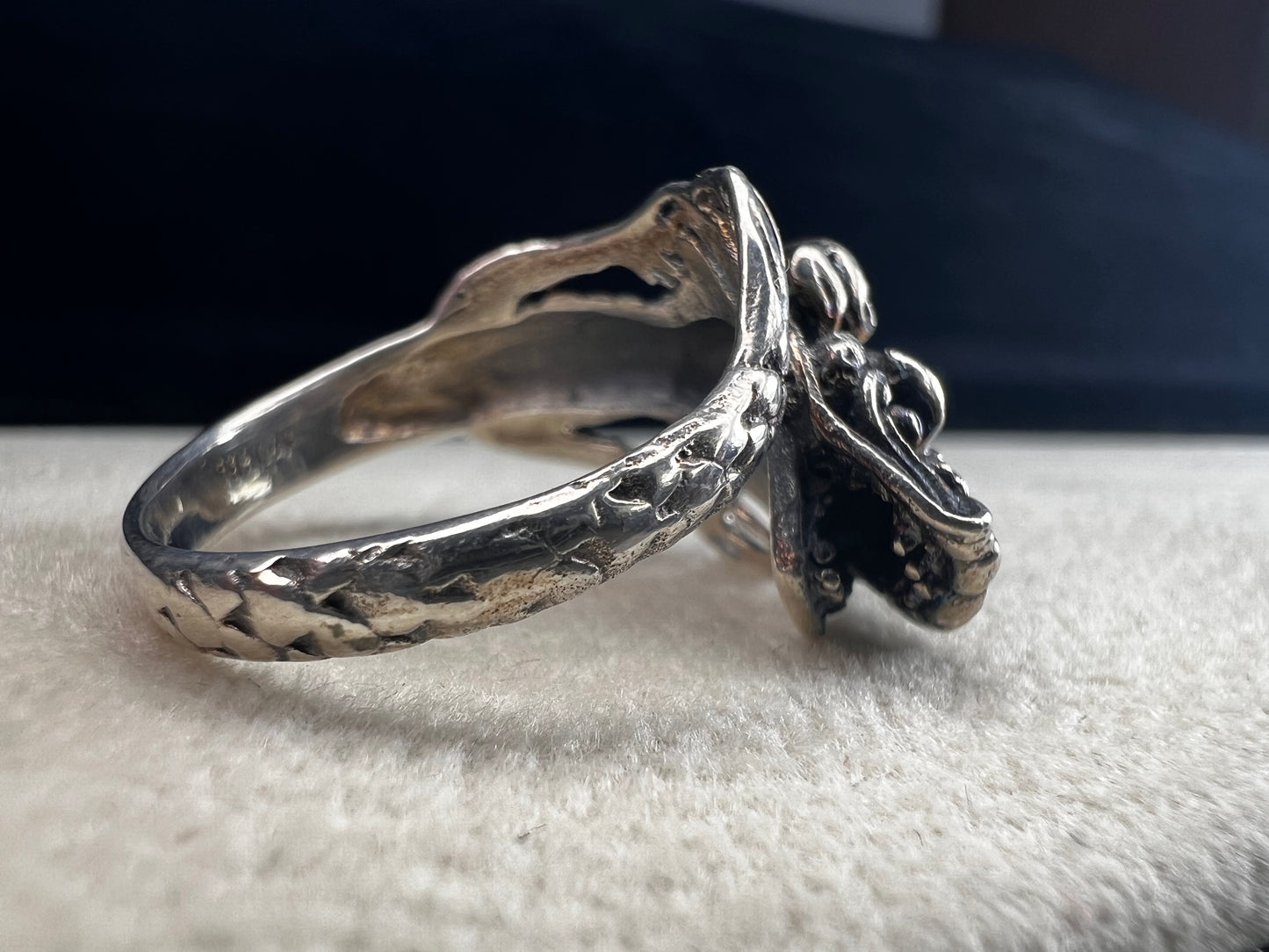 Add a touch of fierce charm to your style with this sterling silver dragon ring. Its detailed design wraps around your finger like a mythical guardian, making it the perfect statement piece.