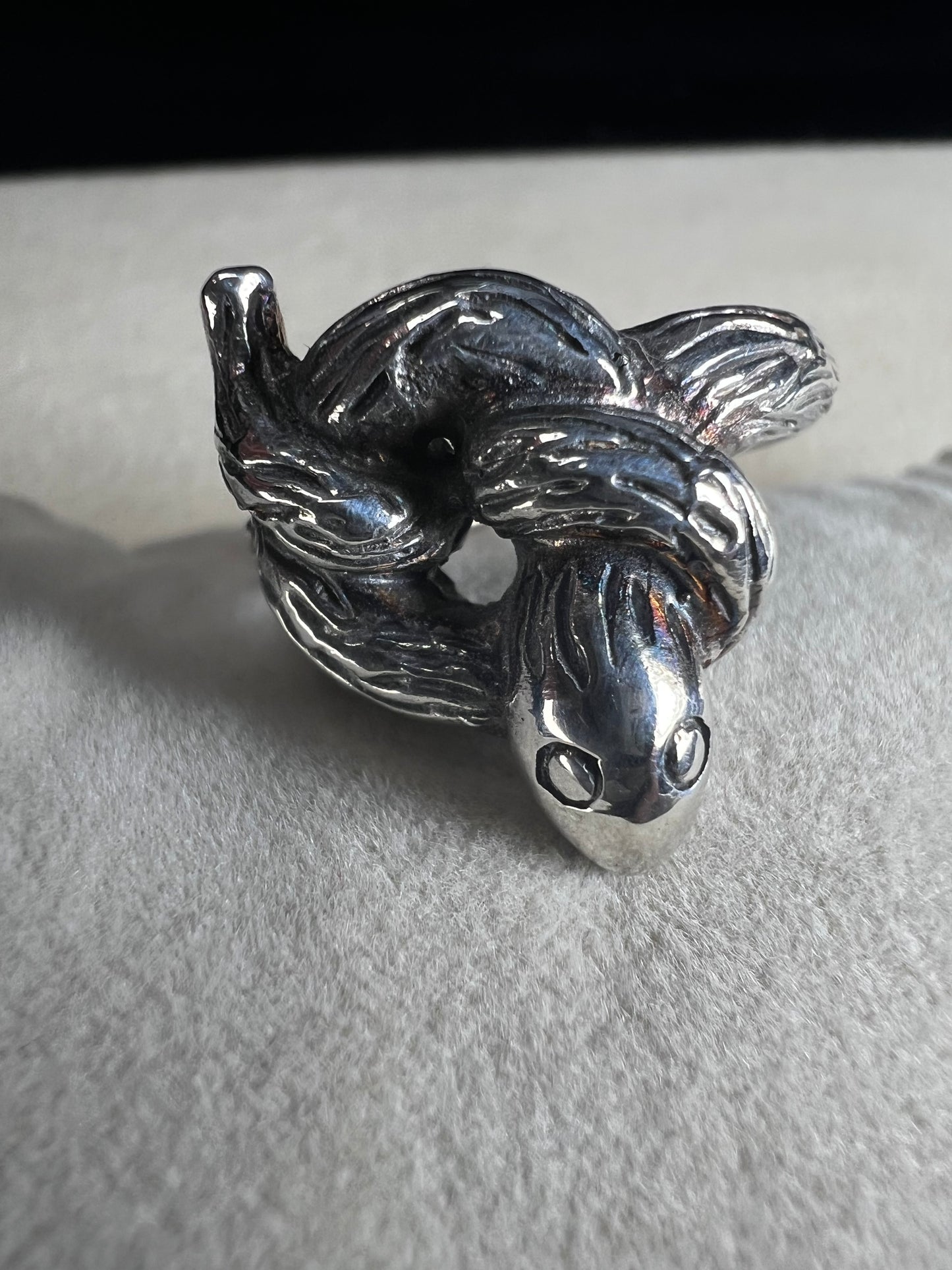 Wrap your finger in mystique with this sterling silver coiled snake ring. Crafted from solid sterling silver, its intricate knotted design adds a playful edge to your look, perfect for those who love a little twist of charm and bold style.