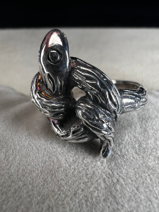 Wrap your finger in mystique with this sterling silver coiled snake ring. Crafted from solid sterling silver, its intricate knotted design adds a playful edge to your look, perfect for those who love a little twist of charm and bold style.