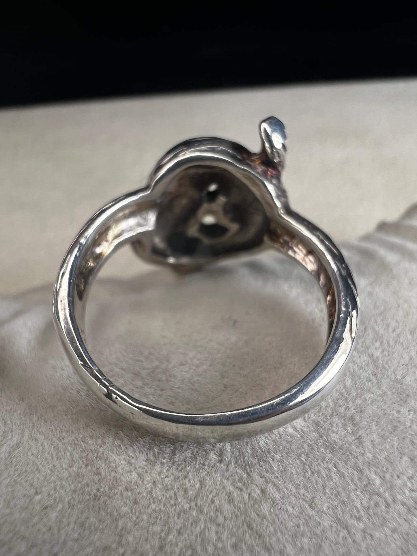 Wrap your finger in mystique with this sterling silver coiled snake ring. Crafted from solid sterling silver, its intricate knotted design adds a playful edge to your look, perfect for those who love a little twist of charm and bold style.