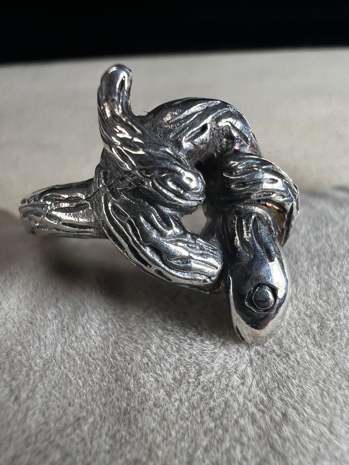 Wrap your finger in mystique with this sterling silver coiled snake ring. Crafted from solid sterling silver, its intricate knotted design adds a playful edge to your look, perfect for those who love a little twist of charm and bold style.
