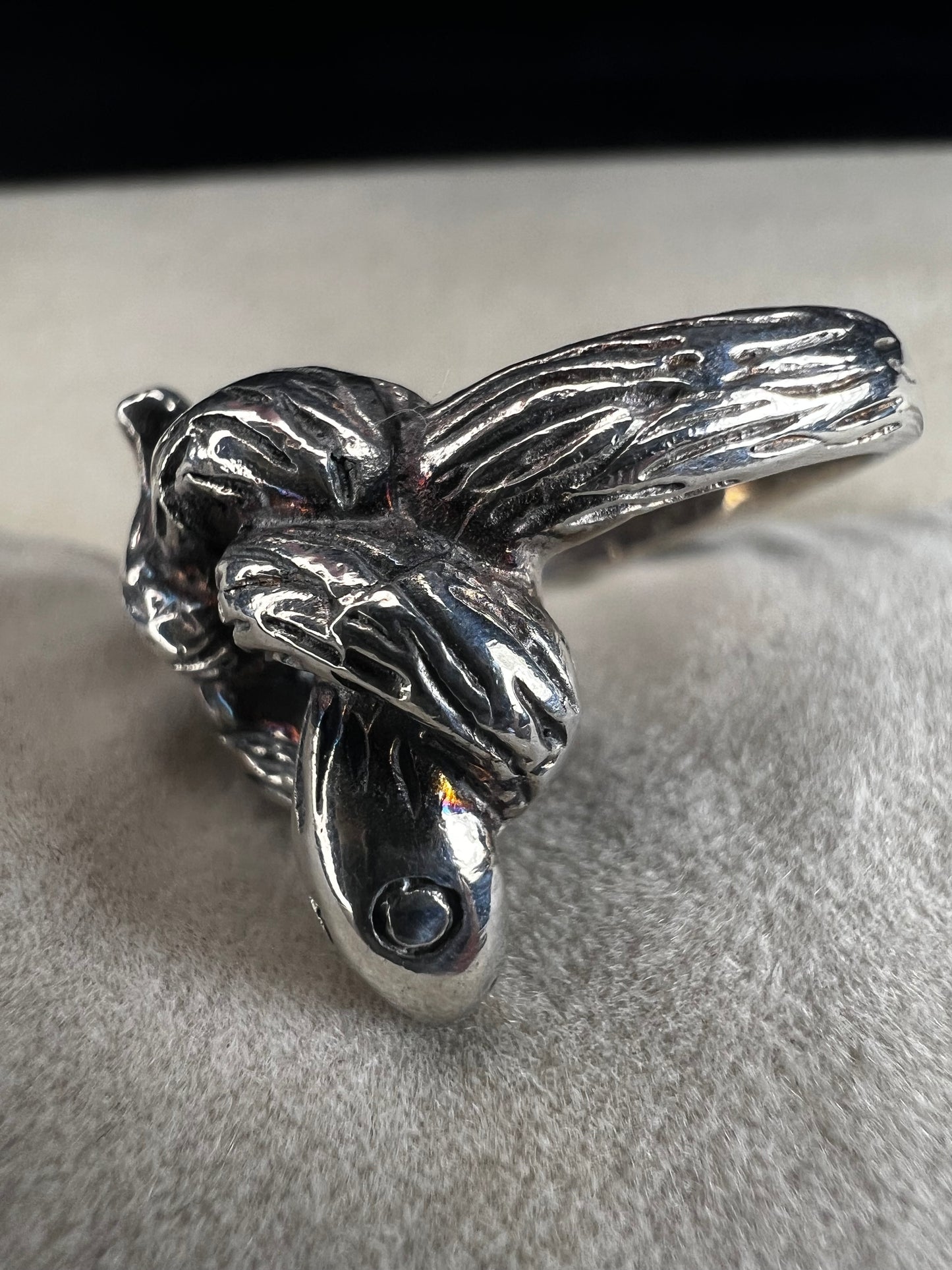Wrap your finger in mystique with this sterling silver coiled snake ring. Crafted from solid sterling silver, its intricate knotted design adds a playful edge to your look, perfect for those who love a little twist of charm and bold style.